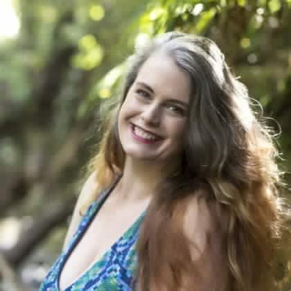 Photo of Mandi Lynn in the bush in a bathing suit.